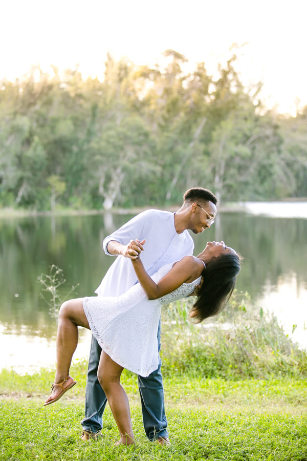 black couple dancing for their engagement photographs at tree tops park south florida