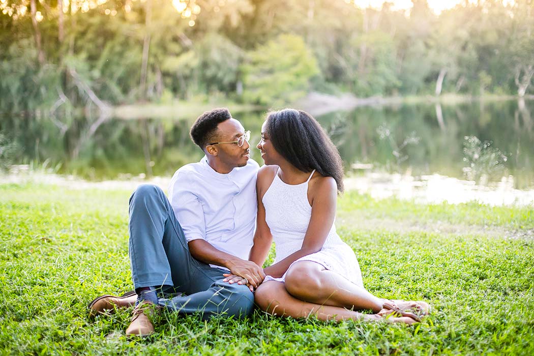 black couple pose on wooden bridge for their engagement photoshoot in south florida | tree tops park