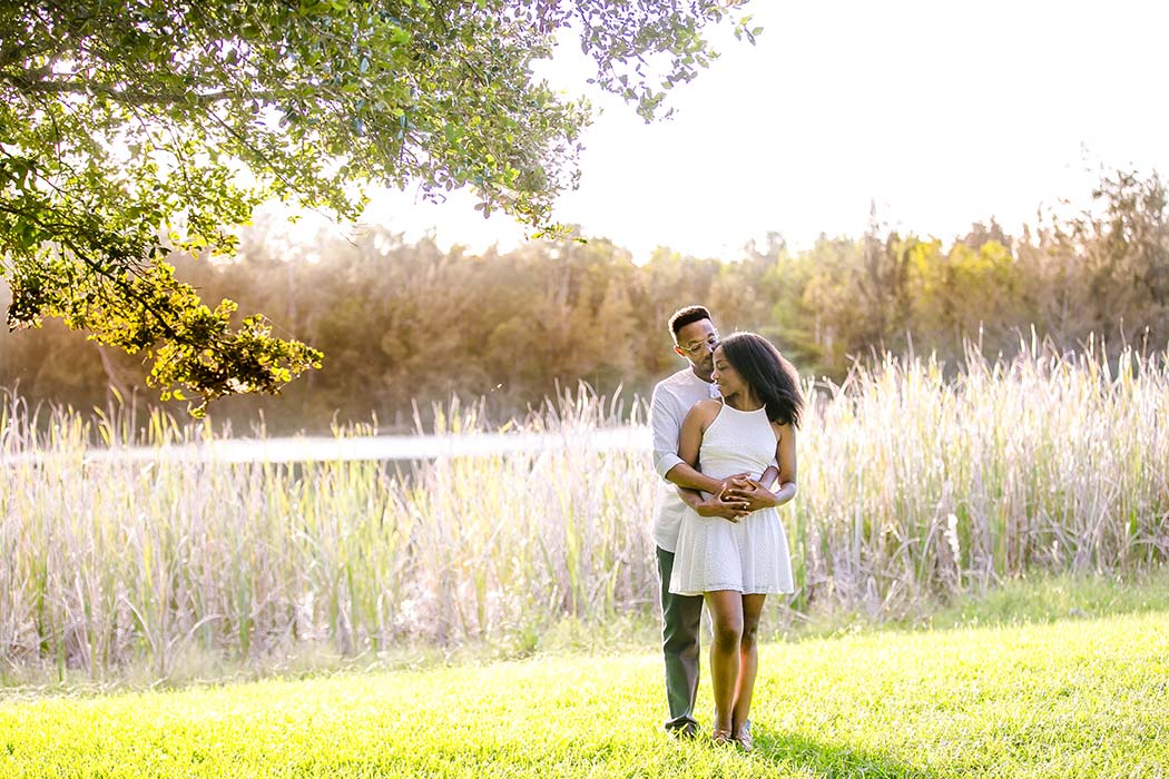 black couple dancing during romantic engagement photoshoot at tree tops park