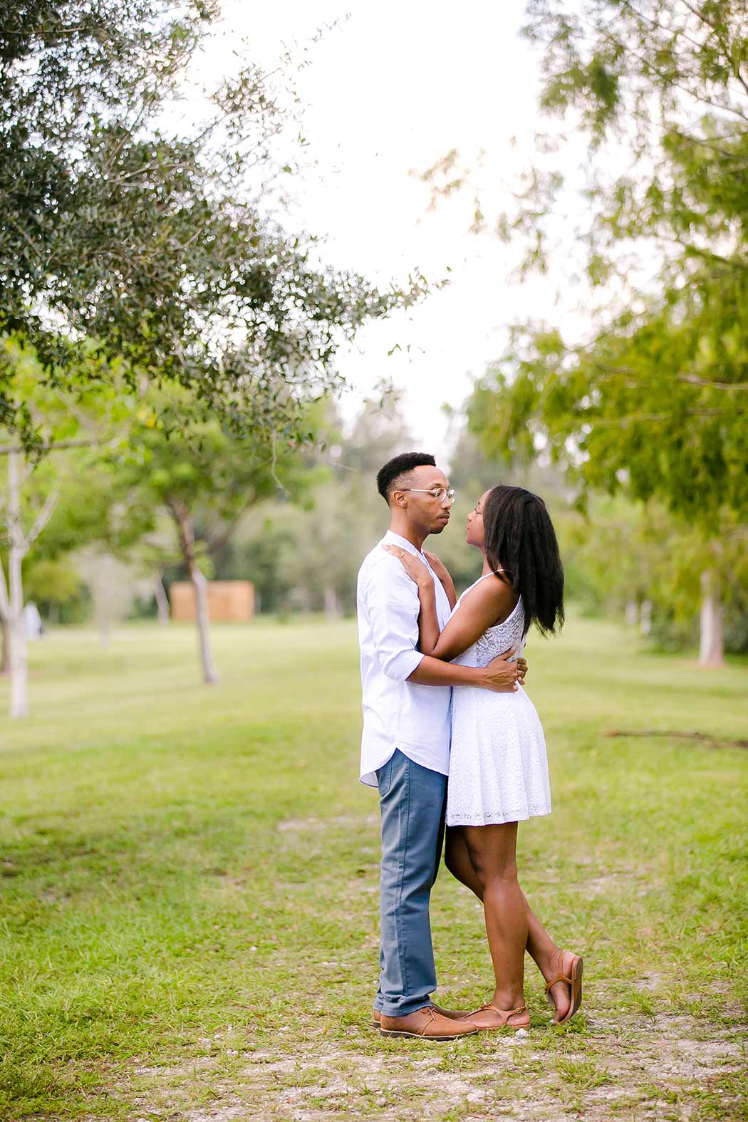 black couple wearing white hugging during engagement photoshoot | engagement photographer south florida