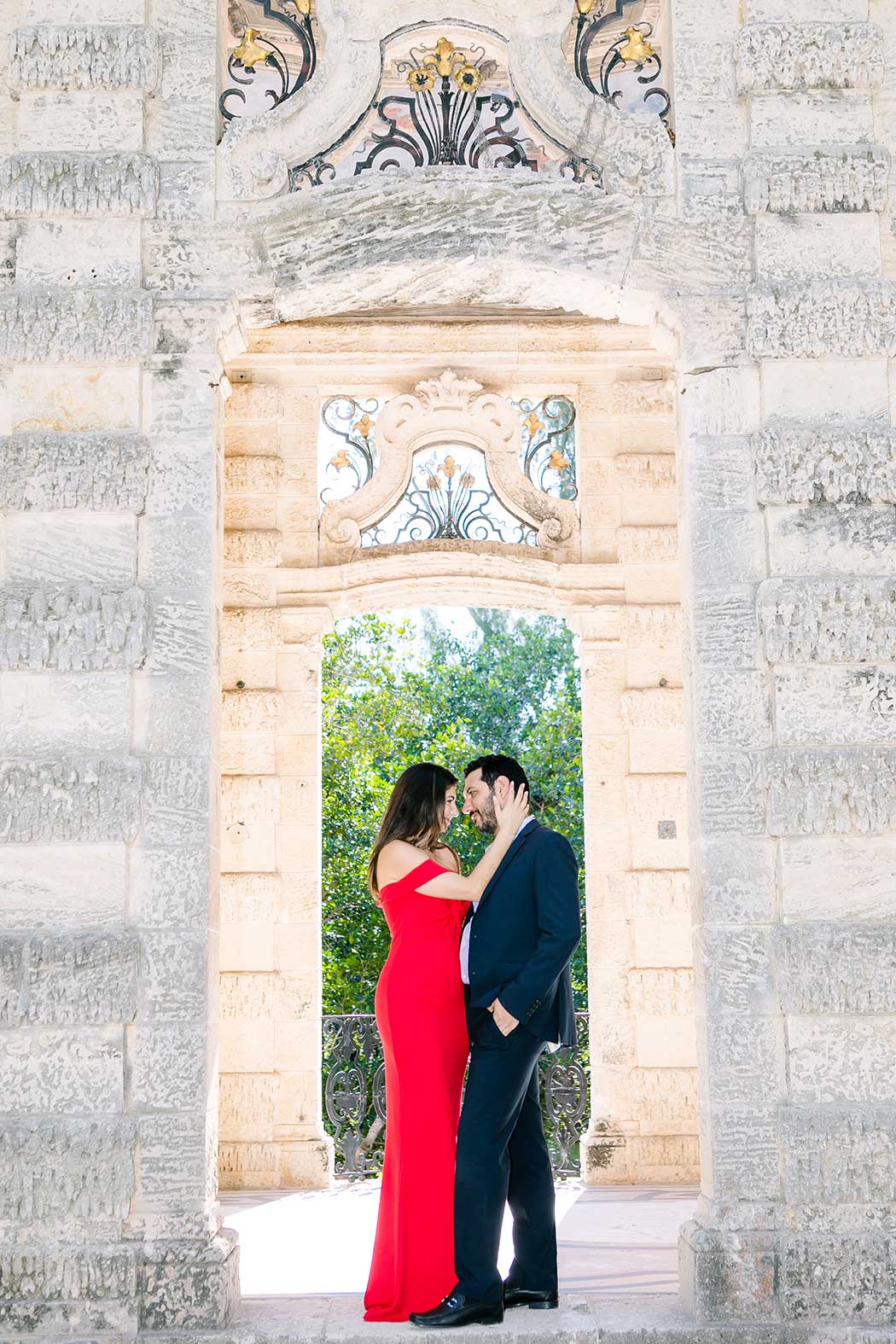 beautiful pose for engagement photoshoot at vizcaya museum miami | long red dress for engagement