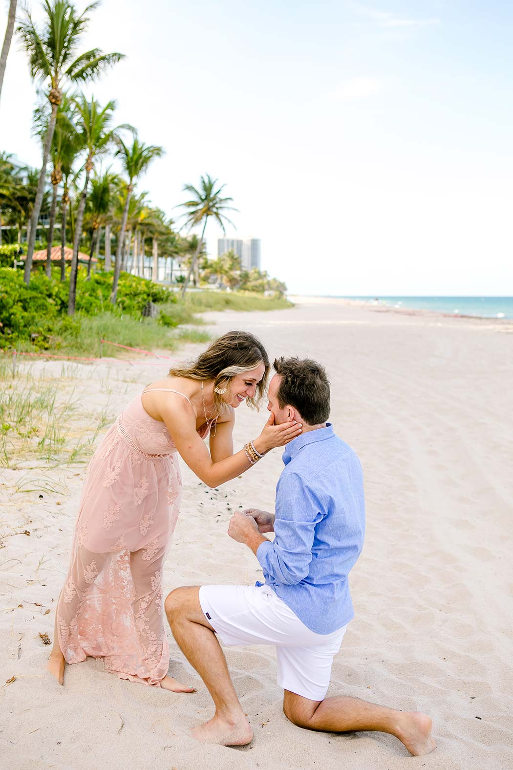 couple embrace on fort lauderdale beach after recently getting engaged | engagement photography fort lauderdale beach