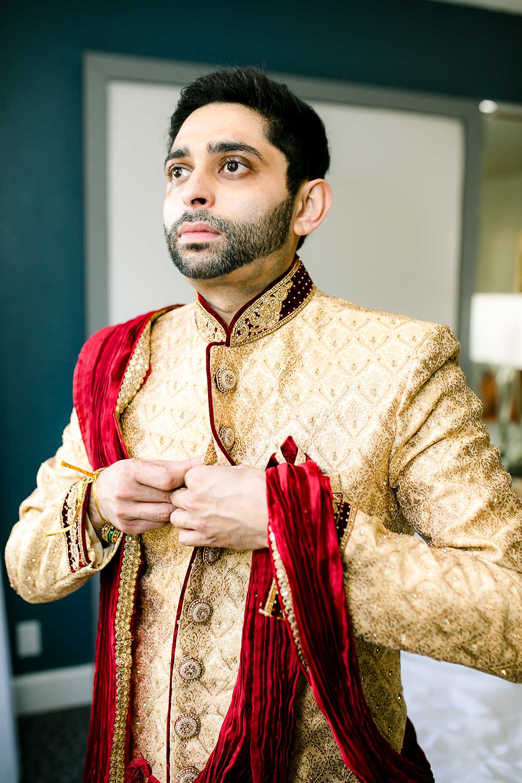 indian groom gets ready for wedding | gold and red indian groom outfit
