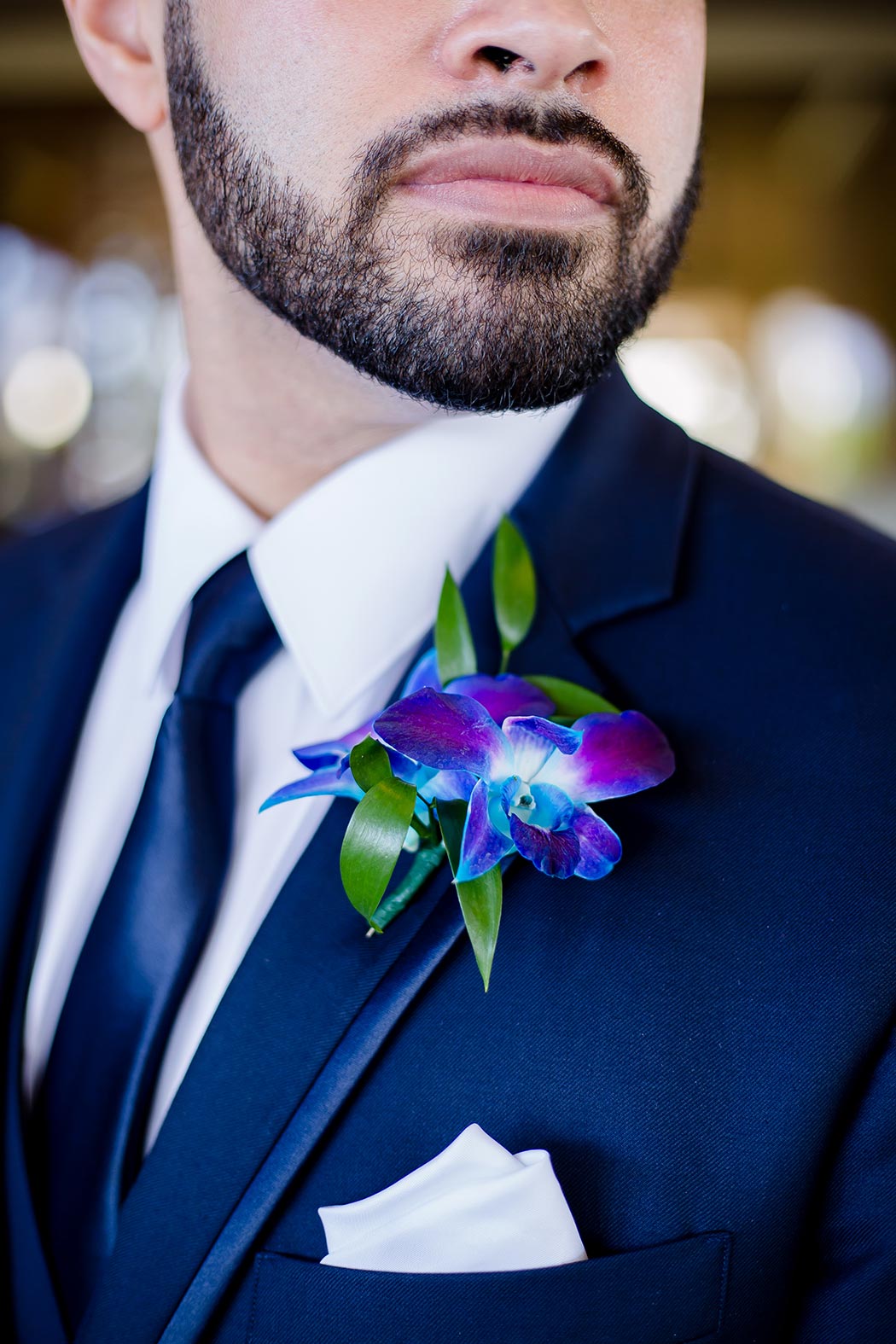 grooms purple orchid boutonniere | close up of groom purple boutonniere
