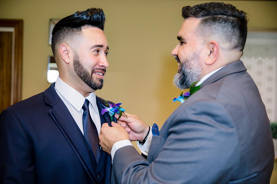 groom getting ready for wedding at breakers west country club | best man putting on boutonniere 