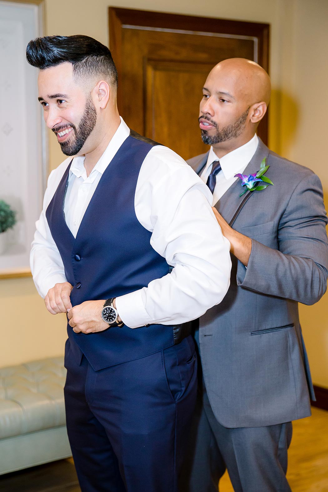 groom getting ready for wedding at breakers west country club | photo of best man helping groom get ready