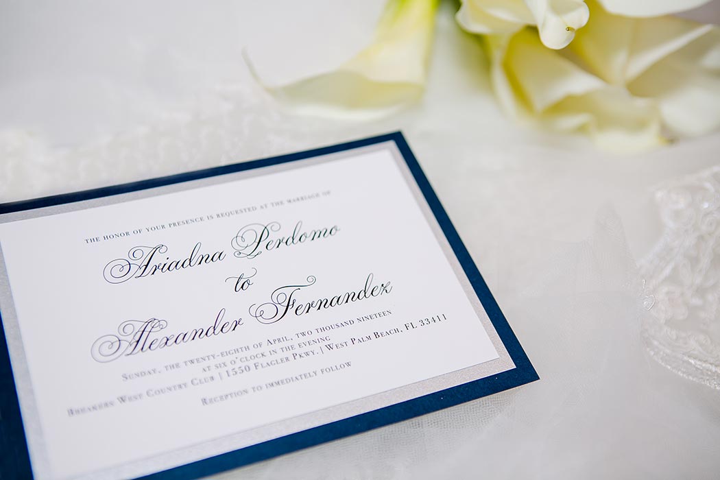 modern wedding stationery with blue and white | photographing wedding invite with flowers and veil