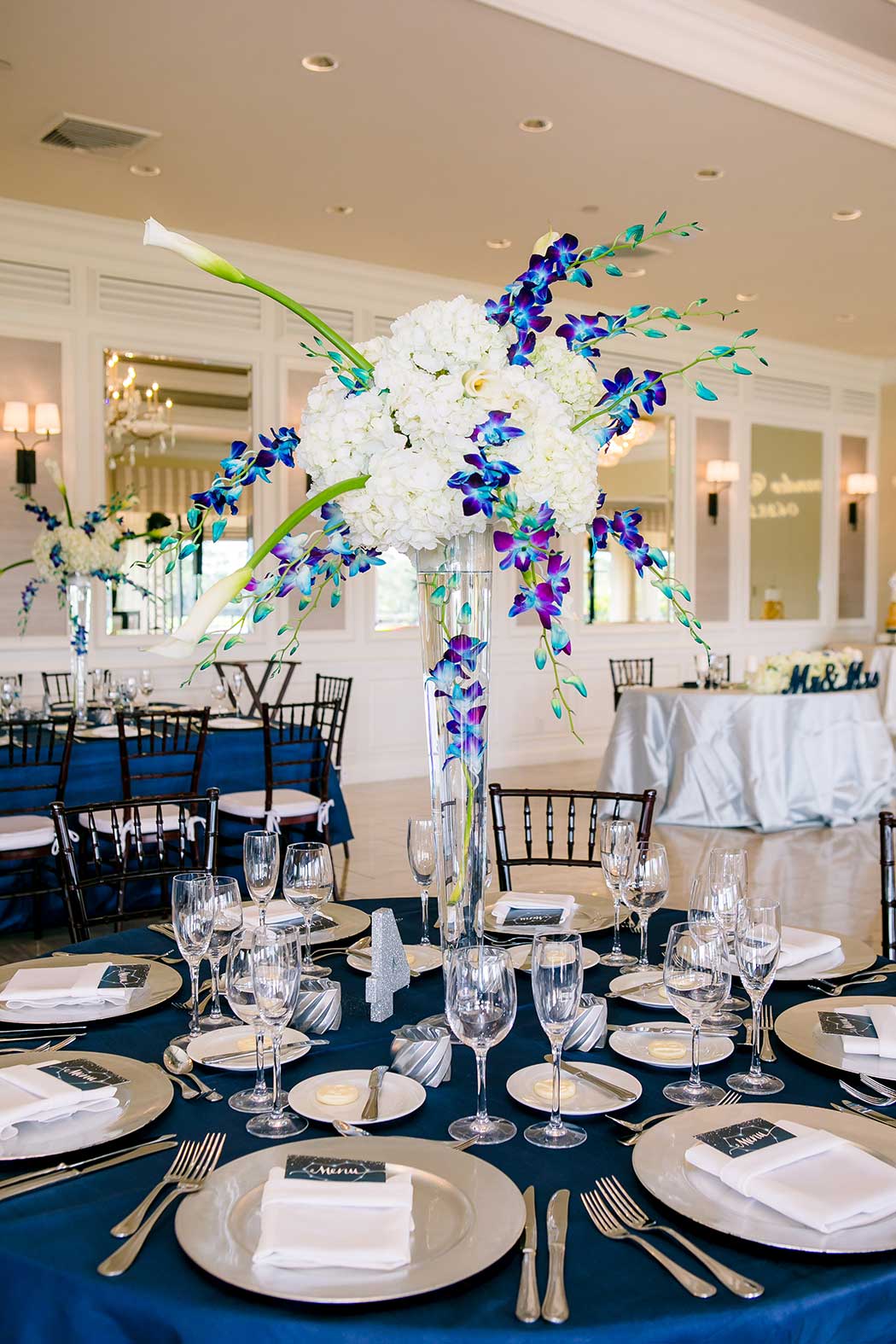 purple and white orchid large wedding table display | blue and white wedding reception
