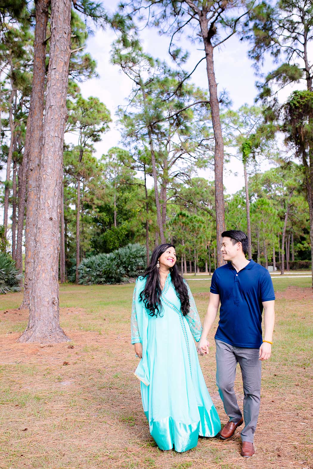 couple walking through trees at morikami | park engagement session south florida | south florida engagement photographer | fort lauderdale engagement photographer