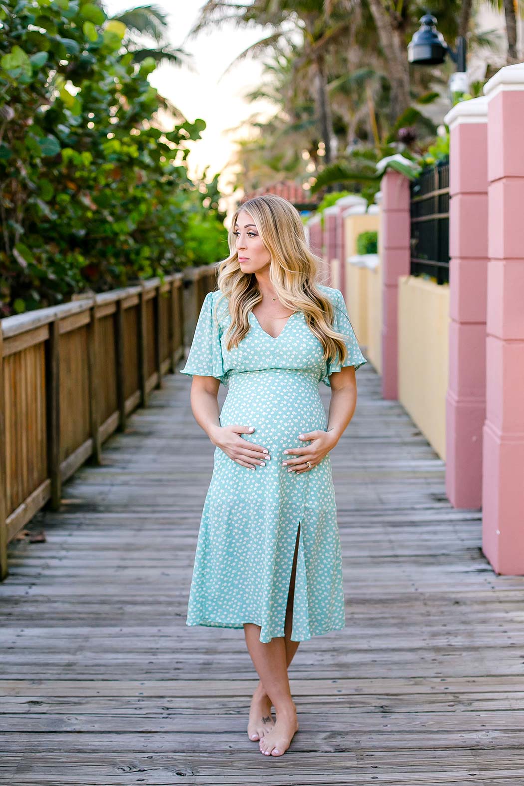 blonde girl green and white maternity dress | maternity pose idea | ideas for maternity pose photoshoot | beach maternity photoshoot south florida | south florida maternity photographer