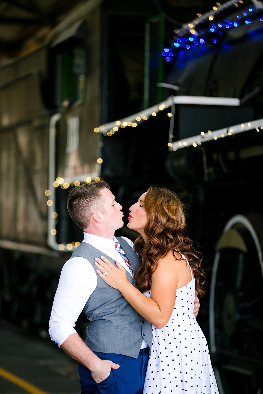 vintage engagement photoshoot at railroad museum | vintage white and black polka dot dress | antique engagement photoshoot