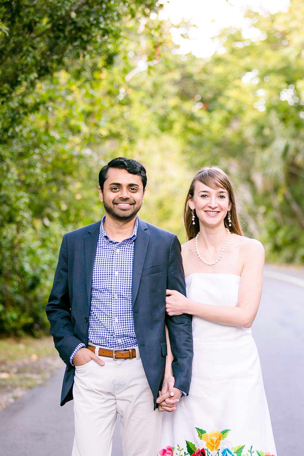 girl holds arm of fiance | unique engagement posing idea | indian couple's engagement photoshoot