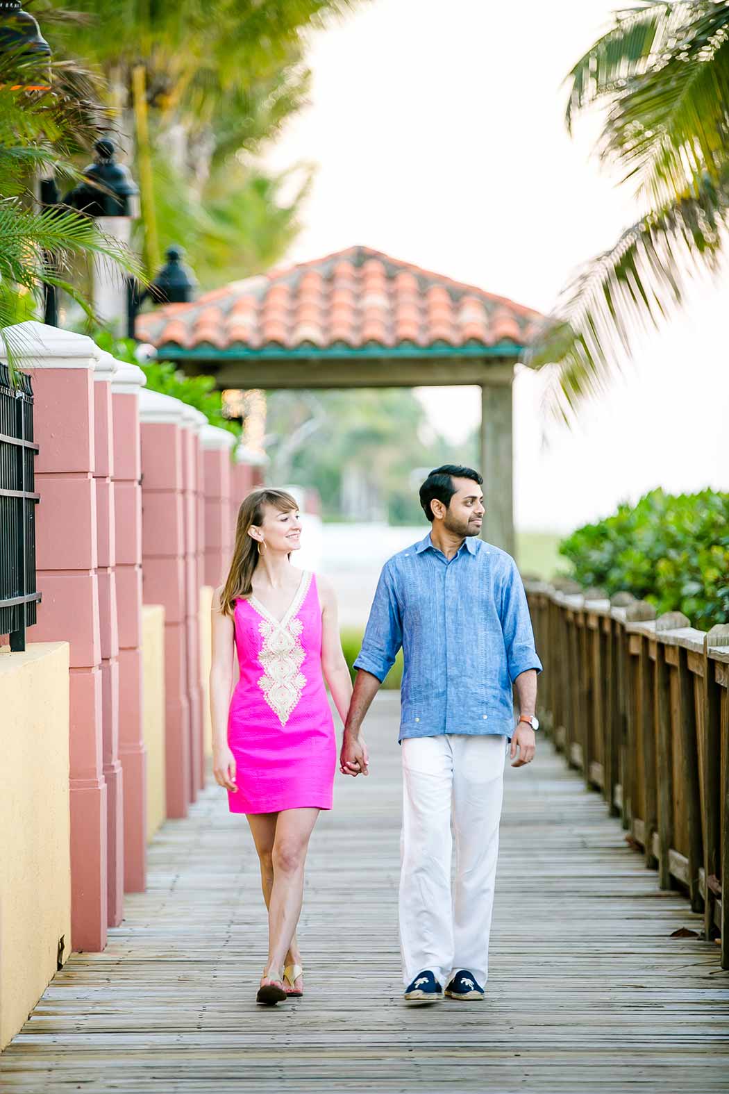 engaged couple walk on wooden walkway | fort lauderdale beach engagement | beach engagement photography fort lauderdale | beach walkway photoshoot in south florida