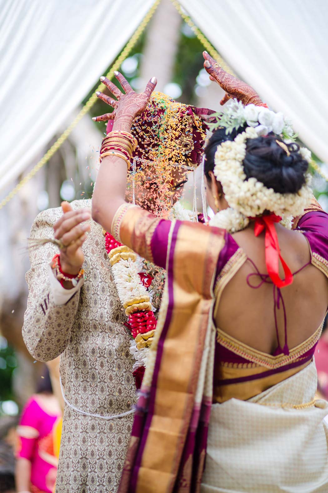 indian bride and groom shower each other with rice during indian wedding at bahia mar fort lauderdale