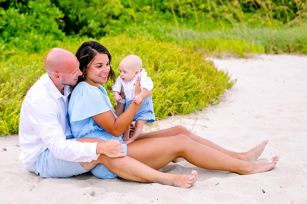 unique surprise beach proposal in fort lauderdale | unique beach engagement photoshoot | sitting down pose for family of 3 photographs