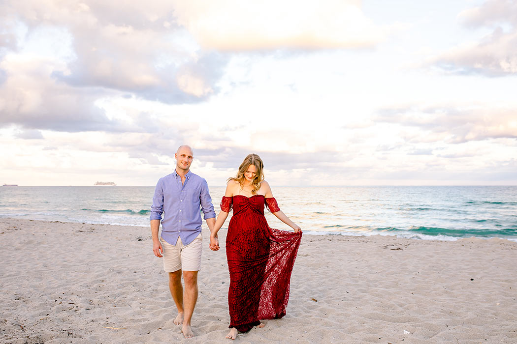 woman and man pose for maternity photography | cute maternity pose | maternity photoshoot on beach | maternity photographer fort lauderdale | dania beach maternity with pier