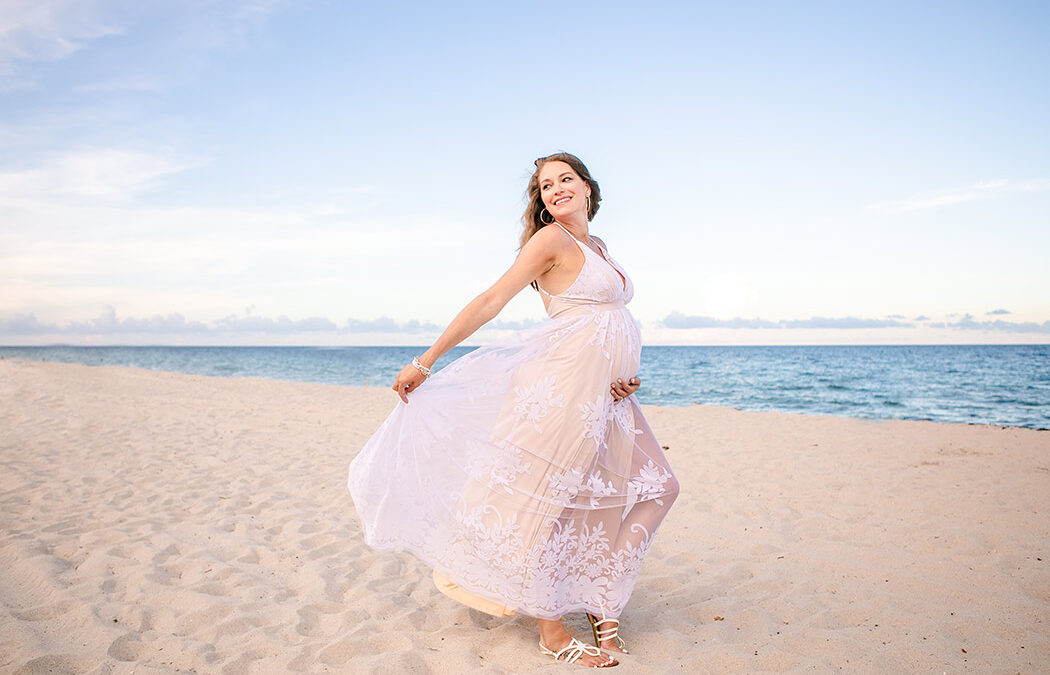lady poses during beach maternity session