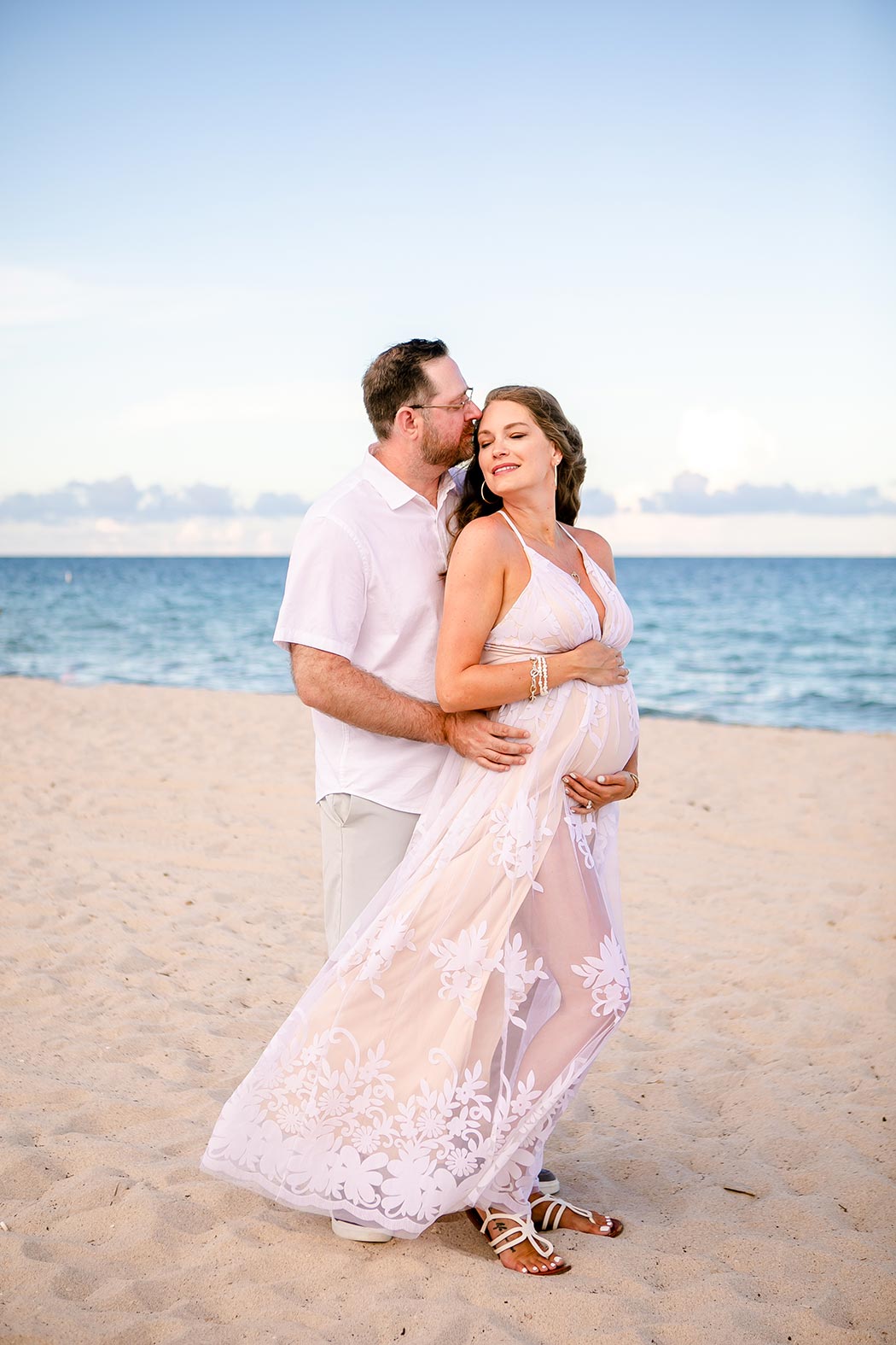 couple posing on beach in fort lauderdale for maternity photoshoot | maternity photographer fort lauderdale | fort lauderdale maternity photoshoot