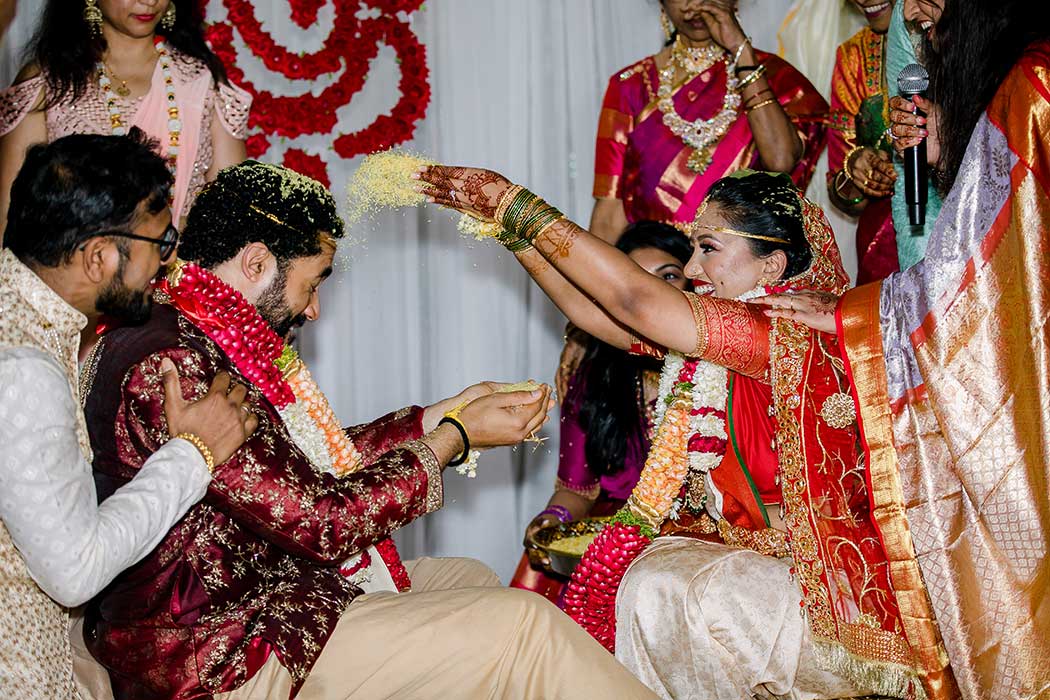 indian bride and groom throw rice during ceremony | traditional Hindu wedding ceremony in south flirida