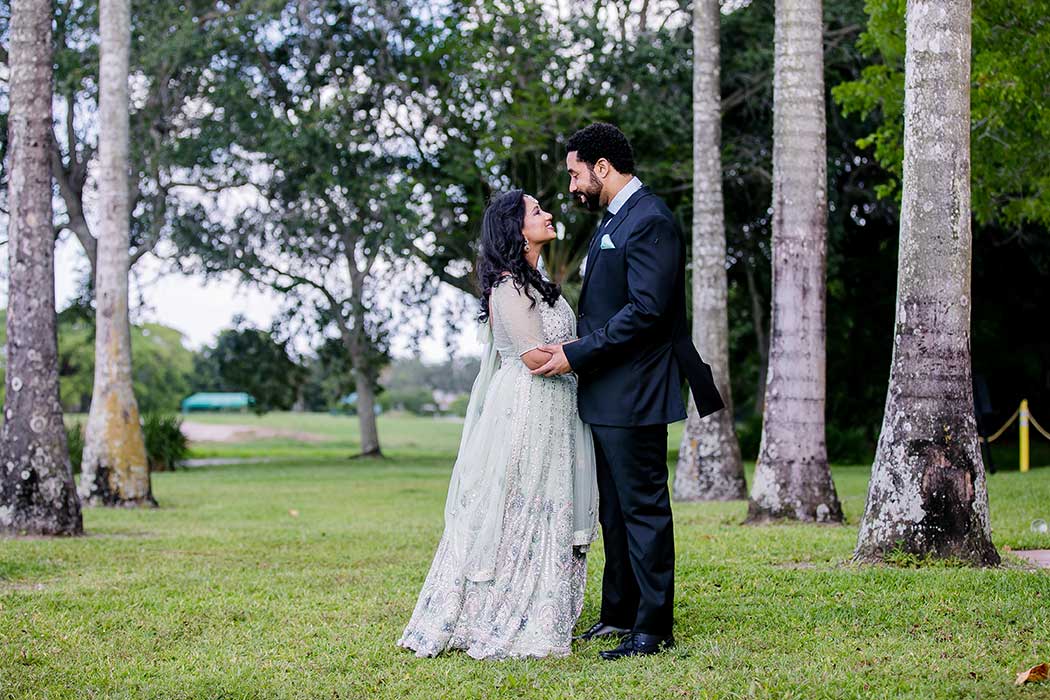 bride and groom smiling for wedding pictures in fort lauderdale  | south florida Hindu wedding bride and groom