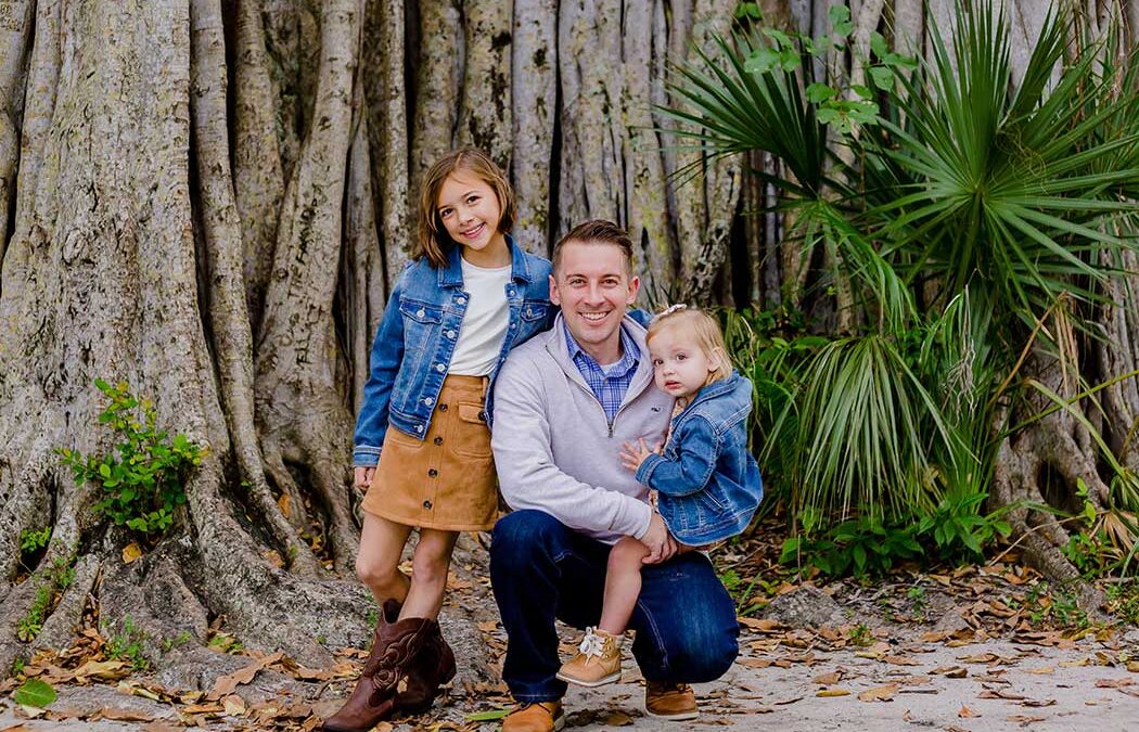 A father and two children enjoying a photoshoot in Robbins Preserve, Davie