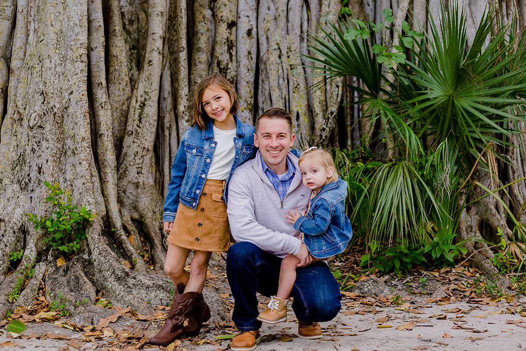 A father and two children enjoying a photoshoot in Robbins Preserve, Davie