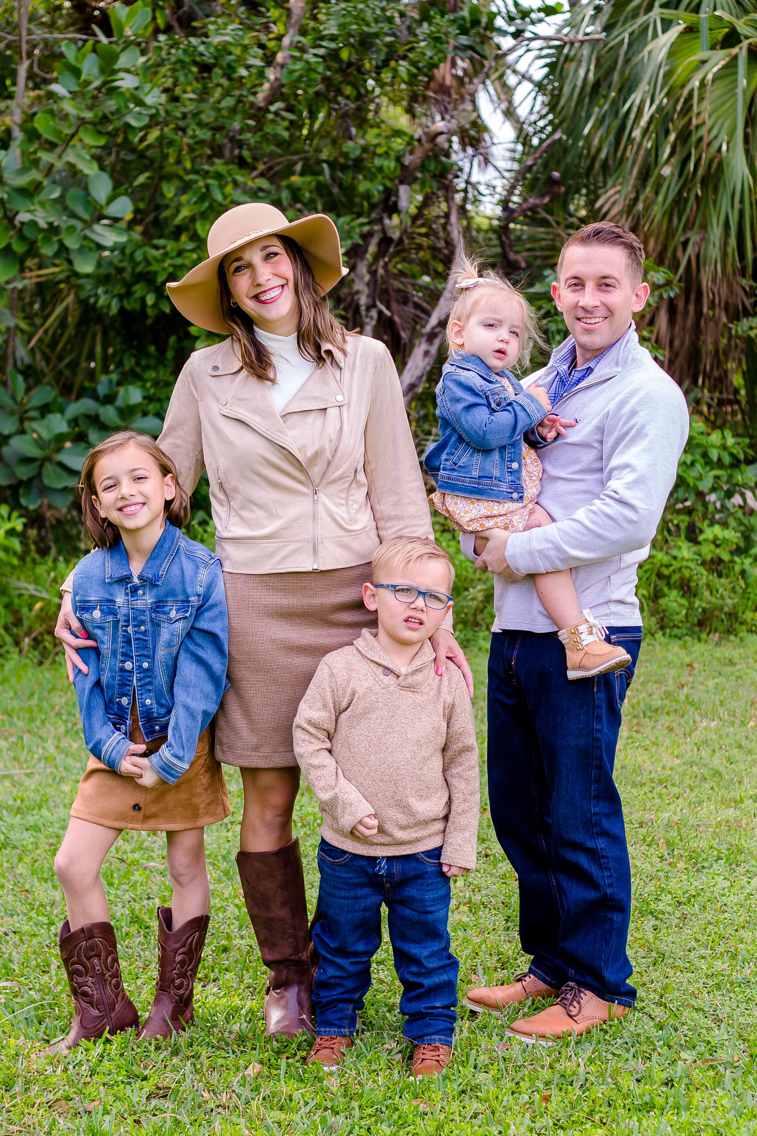 family of 5 smile happily in robbins preserve for family photography session