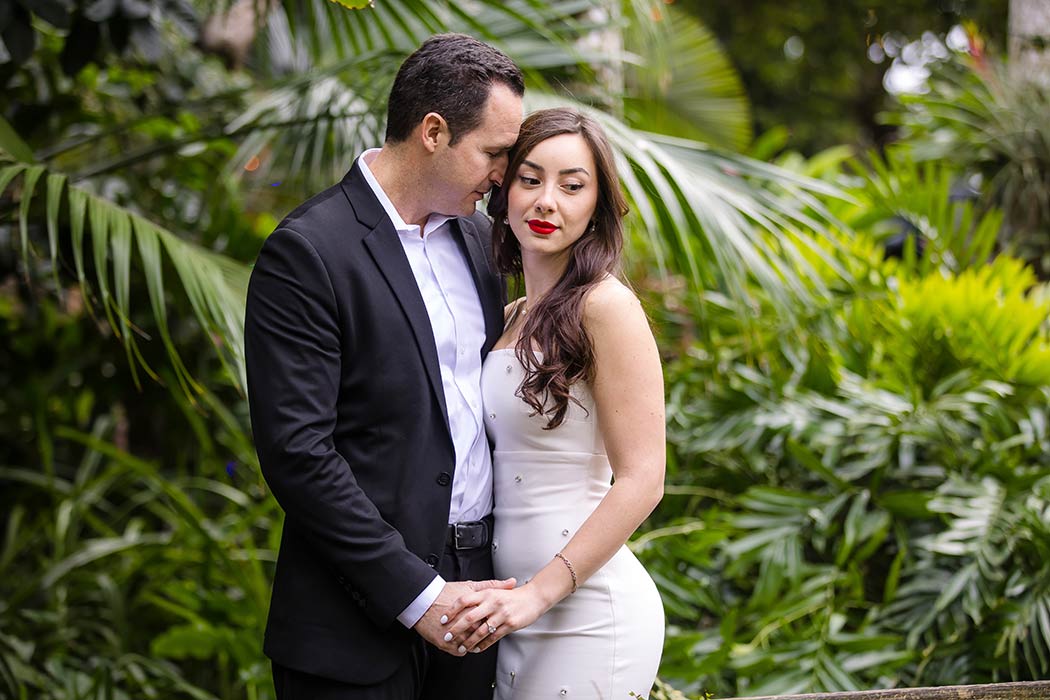 Couples photography session at Flamingo Gardens, South Florida with vibrant tropical plants in the background