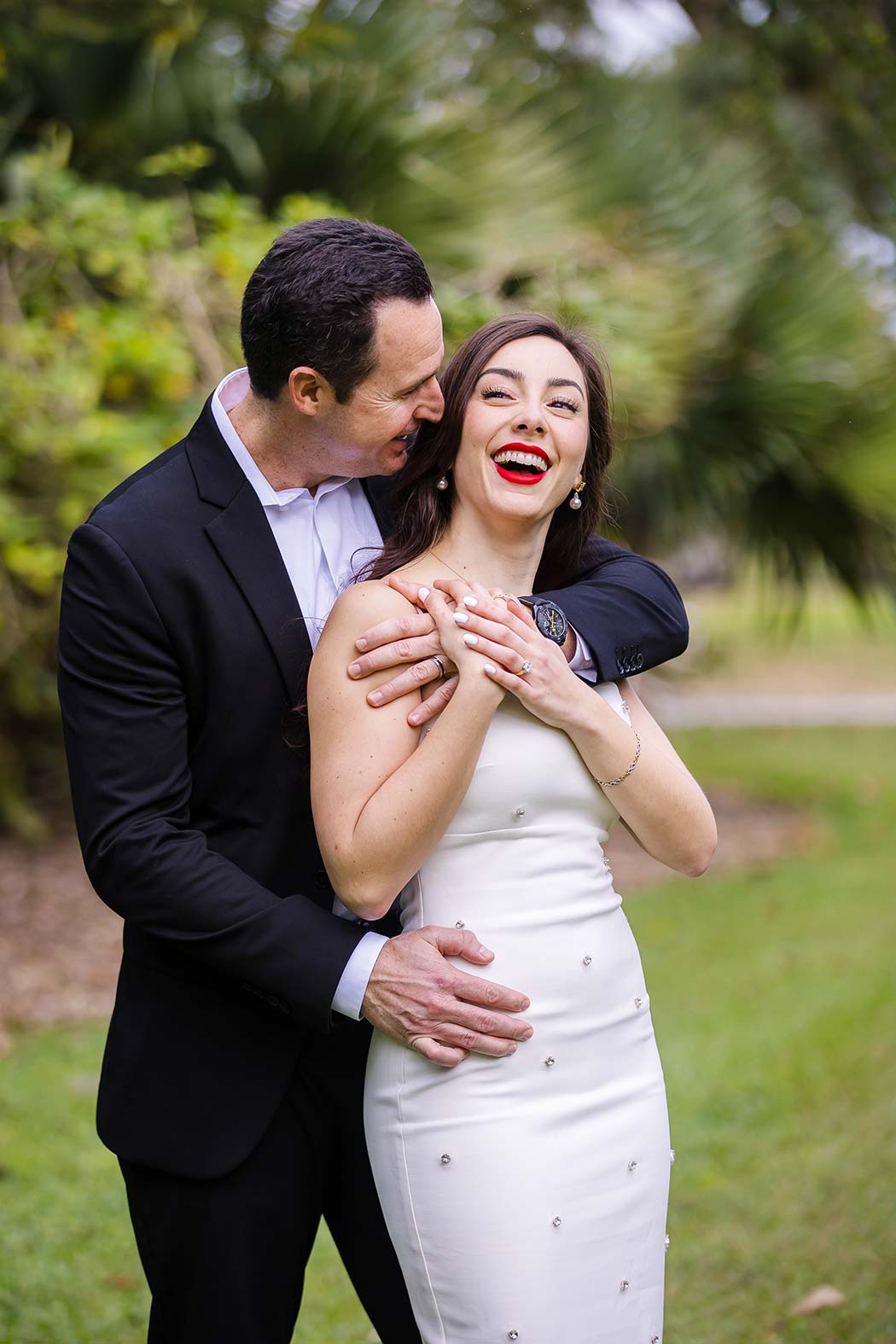 Beautiful couple pose for engagement photos against lush backdrop of flamingo gardens