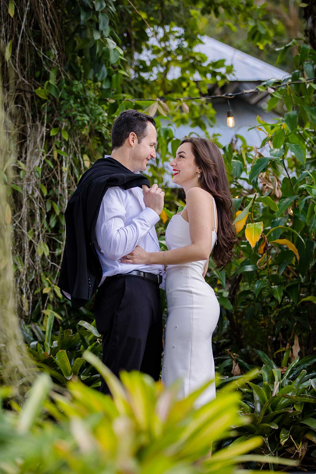 Unique pose with couple leaning against a tree during engagement photoshoot