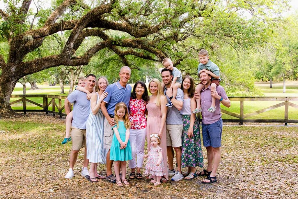 large family photography session in a fort lauderdale park, captured by Fort Lauderdale photographer Andrea Harborne. Bright, natural light and connection between family members. Extended family photoshoot