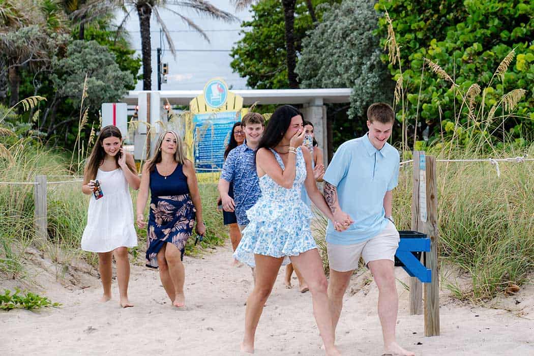 Bride-to-be sees the ‘Will You Marry Me’ sign during a surprise beach proposal in Fort Lauderdale